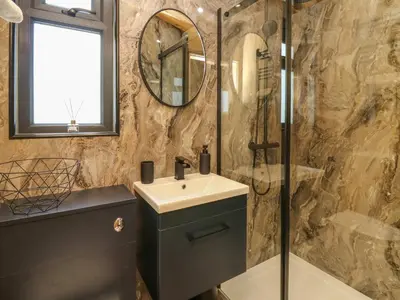a bathroom with a sink and a shower at Hen's Hideaway in Saint Harmon