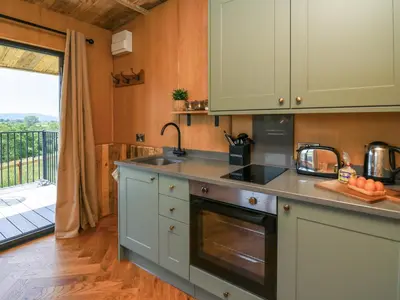 a kitchen with a sink and a stove at Hen's Hideaway in Saint Harmon