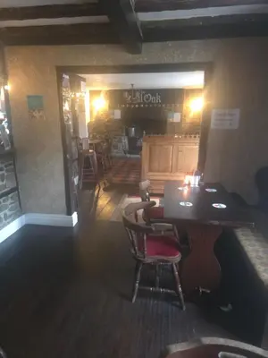 a dining room with a table and chairs in a restaurant at The Royal Oak Inn, Rhandirmwyn in Rhandirmwyn