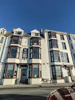 a large building on a street with a car parked in front at Cardigan and Celtic Bay Guest House - Self Catering Accommodation in Aberystwyth