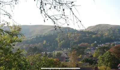 a view of a town in the hills at LARCHES LODGE Norwegian log cabin, wood stove & spa in Church Stretton