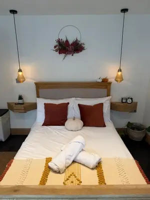 a bedroom with a bed with two towels on it at Luxury Courtyard Studio in Llangollen in Llangollen