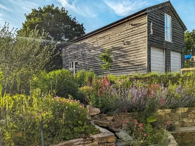 an old house with a garden in front of it at Studio At The Green in Shrewsbury