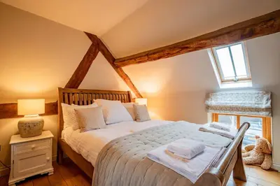 a bedroom with a large bed in a attic at Oak Barn, Ludlow in Ludlow