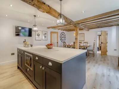 an open kitchen and dining room with a dining table at Hares Hollow - Uk33953 in Llanymynech