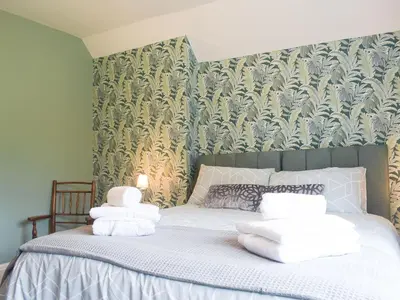 a bedroom with a bed with white towels on it at The Woodshed in Letton