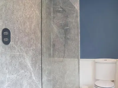 a shower stall in a bathroom with a toilet at The Woodshed in Letton