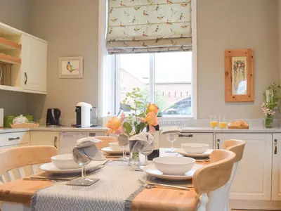 a kitchen with a table with plates and bowls on it at The Woodshed in Letton