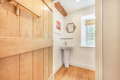 a bathroom with a sink and a window at Ty Glyn Mansion Cottage in Ciliau-Aeron