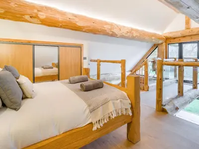 a bedroom with a bed and a large window at Hope Hideaway in Leighton