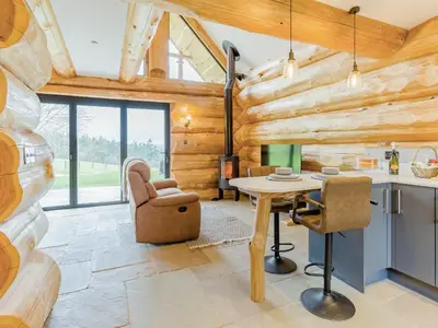 a kitchen and living room with a table and chairs at Hope Hideaway in Leighton