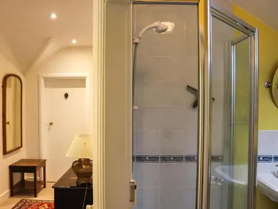 a bathroom with a shower with a glass door at Bryn Hyfryd in Harlech