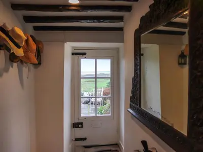 a mirror in a room with a window and a window at Bryn Hyfryd in Harlech