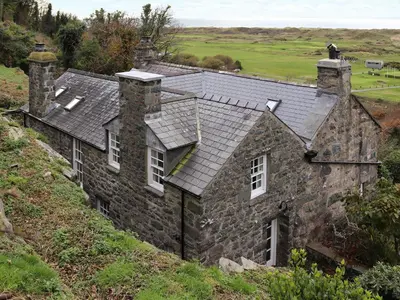 an old stone house on the side of a hill at Bryn Hyfryd in Harlech