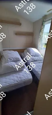 two beds sitting next to each other in a bedroom at Astral 138 snowdon summit 098 in Barmouth
