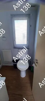 a bathroom with a toilet and a window at Astral 138 snowdon summit 098 in Barmouth