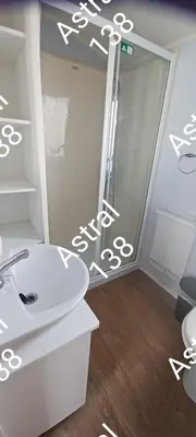 a bathroom with a white sink and a shower at Astral 138 snowdon summit 098 in Barmouth