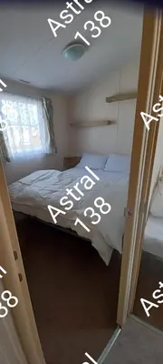 a bedroom with a bed with the word krone written on it at Astral 138 snowdon summit 098 in Barmouth