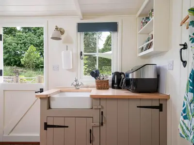 a kitchen with a sink and a window at Collen in Llanarth