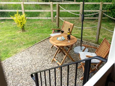 a balcony with a table and chairs and a fence at Bedwen in Llanarth