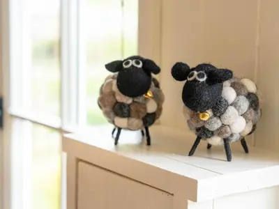 two sheep figurines sitting on top of a counter at Onnen in Llanarth