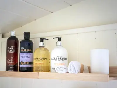four bottles of alcohol sit on a shelf in a kitchen at Onnen in Llanarth