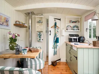 a kitchen with a table and a counter top at Onnen in Llanarth