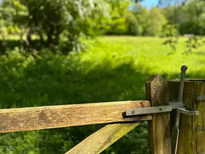 a close up of a wooden bench with a strap at Onnen in Llanarth