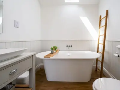 a white bathroom with a tub and a sink at School House Victorian elegance by the river with parking Pass the Keys in Shrewsbury