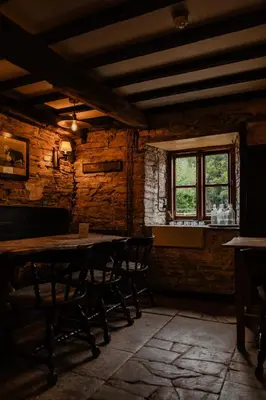 a dining room with a table and chairs and a window at The Bulls Head Wild Cabins in Hereford
