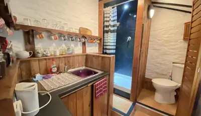 a small kitchen with a sink and a toilet at Fisherman's Cottage in Aberystwyth