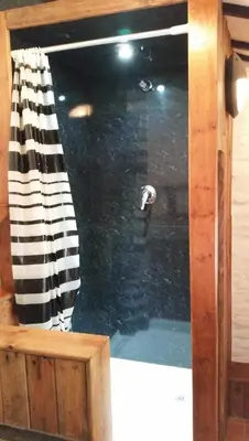 a window of a pool of water with a shower curtain at Fisherman's Cottage in Aberystwyth