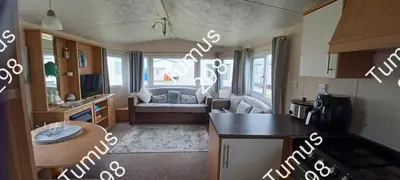 a kitchen and a living room with a couch at Tumus 298 sandy cove 066 in Barmouth