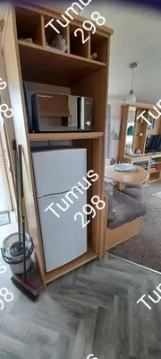 a kitchen with a refrigerator in a room at Tumus 298 sandy cove 066 in Barmouth