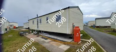 a mobile home with graffiti on the side of it at Tumus 298 sandy cove 066 in Barmouth