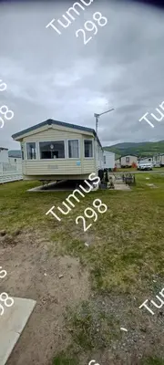 a mobile home is parked in a field at Tumus 298 sandy cove 066 in Barmouth