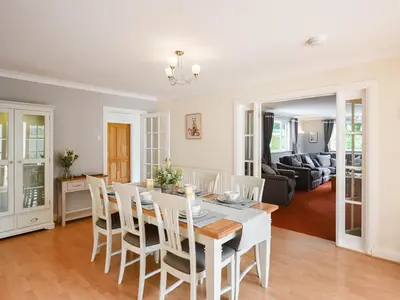 a dining room and living room with a table and chairs at The Bungalow in Castle Caereinion