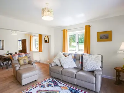a living room with two couches and a table at The Lodge At Harvest Farm in Ludlow