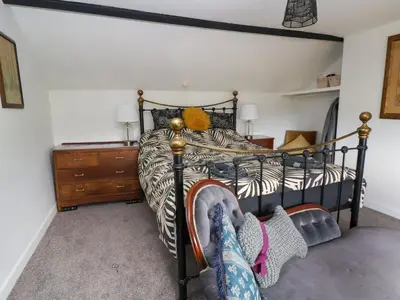 a bedroom with a black and white bed and a dresser at Aelybryn in Oswestry