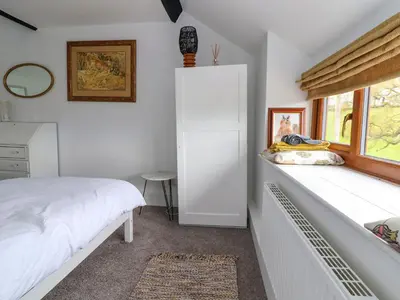 a bedroom with a bed and a window at Aelybryn in Oswestry
