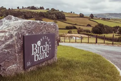 a sign for a british bank on the side of a road at Birch Banc Retreats - Glyn-Haul, New Enc Decking in Llanidloes