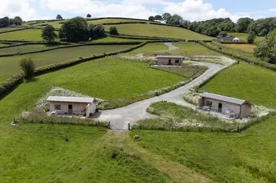 an aerial view of a farm with a winding road at Birch Banc Retreats - Glyn-Haul, New Enc Decking in Llanidloes