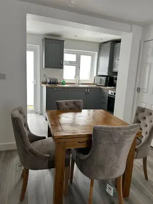 a kitchen with a wooden table and chairs at Cottage in Ludlow in Ludlow
