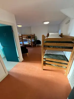 a room with two bunk beds in a room at Llety Glyndwr - Bunkhouse in Trawsfynydd