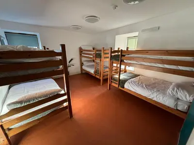 a group of bunk beds in a room at Llety Glyndwr - Bunkhouse in Trawsfynydd