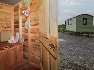 a door to a cabin with a green shed at Shepherd's Hut at Penrallt Goch in Blaenau-Ffestiniog