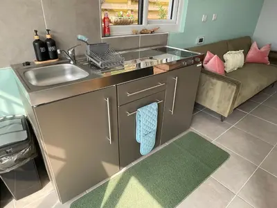 a kitchen with a sink and a dishwasher at Penrallt Bach in Blaenau-Ffestiniog