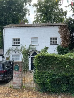 a white house with a fence in front of it at St Julians house in Shrewsbury