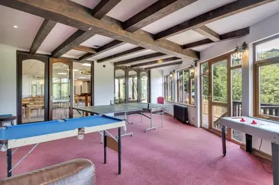 a room with two ping pong tables and windows at White Waters Bed and Breakfast in Llangollen