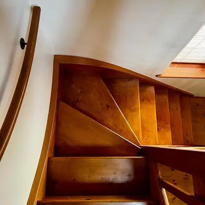 a wooden staircase in a room with a ceiling at Frog Cottage, Ludlow - a charming townhouse for 4 in Ludlow